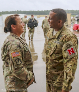 A male and female National Guard Member wearing their uniforms and talking