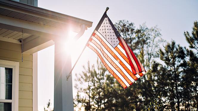 American flag in front of home purchased with a VA house loan