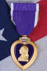 Purple heart medal resting on an American flag